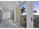Bright lanai with sliding glass doors and ocean view at 2110 Benjamin Franklin Dr # 105, Sarasota, FL 34236