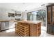 Modern kitchen with butcher block island, wine rack, and stainless steel appliances at 2332 Pinehurst St, Sarasota, FL 34231