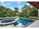 Inviting pool and spa surrounded by lush tropical landscaping at 2332 Pinehurst St, Sarasota, FL 34231