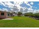 Spacious backyard with grassy lawn, patio, and canal access at 2506 41St E St, Bradenton, FL 34208