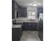 Newly remodeled kitchen, dark gray cabinets, granite counters, and stainless steel appliances at 307 1St Sw Ave, Lutz, FL 33548