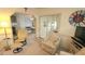 Bright living room with comfy armchairs and view into dining area at 3333 26Th E Ave # 1148, Bradenton, FL 34208