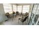 Bright sunroom with four floral chairs, two end tables, and large windows at 3333 26Th E Ave # 1148, Bradenton, FL 34208