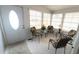 Sunroom with four chairs, a door to the outside, and large windows at 3333 26Th E Ave # 1148, Bradenton, FL 34208