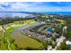 Aerial view of community with water, golf course, and ocean access at 3427 Winding Oaks Dr # 14, Longboat Key, FL 34228