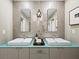 Modern bathroom with double sinks, unique wallcovering and a light-colored vanity at 3427 Winding Oaks Dr # 14, Longboat Key, FL 34228