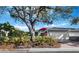 Gray house with two-car garage and landscaping at 3427 Winding Oaks Dr # 14, Longboat Key, FL 34228