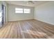 Bright bedroom with wood-look floors, large window, and ceiling fan at 3640 Ironwood Cir # 601N, Bradenton, FL 34209