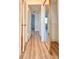 Hallway with light wood-look floors and mirrored closet at 3640 Ironwood Cir # 601N, Bradenton, FL 34209