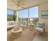 Bright living room featuring large windows, comfortable seating, and a ceiling fan at 3640 Ironwood Cir # 601N, Bradenton, FL 34209