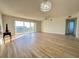 Spacious living room with laminate flooring and balcony access at 3640 Ironwood Cir # 601N, Bradenton, FL 34209