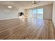 Living room with laminate floors, ceiling fan and balcony view at 3640 Ironwood Cir # 601N, Bradenton, FL 34209