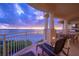 Spacious balcony boasts ocean views, outdoor furniture, and grill at 4125 Gulf Of Mexico Dr # S201, Longboat Key, FL 34228