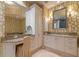 Spa-like bathroom with a vanity, large mirror, and patterned wallpaper at 4125 Gulf Of Mexico Dr # S201, Longboat Key, FL 34228