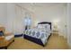Bedroom with a blue upholstered bed and wicker chair at 4125 Gulf Of Mexico Dr # S201, Longboat Key, FL 34228