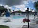 Relaxing community pool area with patio furniture at 4705 1St W Ct # 388, Bradenton, FL 34207