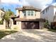 Mediterranean-style home featuring a tile roof, bay window, and spacious driveway, complemented by lush landscaping at 5159 Oxford Dr, Sarasota, FL 34242