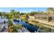 Scenic canal view with lush greenery, a boat dock, and a screened-in patio, perfect for outdoor enjoyment at 521 Cummings St, Sarasota, FL 34242