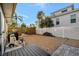 Backyard features palm trees, a privacy fence, and a wood deck, creating a secluded outdoor space at 521 Cummings St, Sarasota, FL 34242