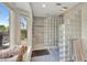 Bathroom featuring a modern glass block shower and a window with an exterior view at 521 Cummings St, Sarasota, FL 34242