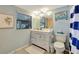 Cozy bathroom featuring a white vanity, framed art, and a window offering natural light at 521 Cummings St, Sarasota, FL 34242