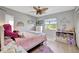 Cozy bedroom with whimsical decor, a ceiling fan, and a bright window view at 521 Cummings St, Sarasota, FL 34242