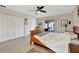 Bright bedroom featuring hardwood floors, a ceiling fan, and closet space at 521 Cummings St, Sarasota, FL 34242