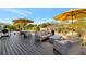 Outdoor deck featuring comfortable seating, an outdoor table with an umbrella, and neighborhood views at 521 Cummings St, Sarasota, FL 34242