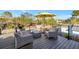 Outdoor deck area with comfortable seating under a bright yellow umbrella at 521 Cummings St, Sarasota, FL 34242