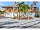 Front exterior displaying the three-car garage, landscaped front yard, and a well-maintained driveway at 521 Cummings St, Sarasota, FL 34242