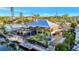 Waterfront home featuring a boat lift, dock, upper deck and pool at 521 Cummings St, Sarasota, FL 34242