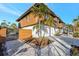 Stilted home with a gated entrance, modern exterior, and manicured landscaping that elevates curb appeal at 521 Cummings St, Sarasota, FL 34242