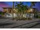 Front exterior view of a stilted home offering ample parking and landscaping, creating a welcoming entrance at 521 Cummings St, Sarasota, FL 34242