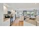 Bright white kitchen with stainless steel appliances and granite countertops at 521 Cummings St, Sarasota, FL 34242