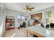 Home office space featuring a desk, exercise bike, ceiling fan, and natural light at 521 Cummings St, Sarasota, FL 34242