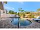 Backyard pool area featuring a paver surround, waterfall feature, and manicured landscaping at 521 Cummings St, Sarasota, FL 34242