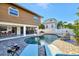 Backyard pool with lounge chairs and bar for outdoor relaxation and entertaining at 521 Cummings St, Sarasota, FL 34242