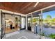 Inviting screened-in porch with an open doorway to the dining and kitchen area, bringing the outdoors in at 521 Cummings St, Sarasota, FL 34242