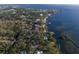 Aerial view of waterfront property with lush landscaping and private dock at 5519 17Th W St, Palmetto, FL 34221