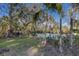 Serene pond surrounded by tropical plants and palm trees at 5519 17Th W St, Palmetto, FL 34221