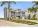 Gray house with stone driveway and palm trees in front at 5531 2Nd Avenue W Cir, Palmetto, FL 34221