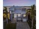 Gray two-story house with metal roof, large windows, and a paved driveway at 5531 2Nd Avenue W Cir, Palmetto, FL 34221