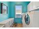 Laundry room featuring a washer, dryer, and storage cabinets at 5531 2Nd Avenue W Cir, Palmetto, FL 34221