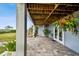 Covered patio with pavers, lush landscaping and waterfront view at 5531 2Nd Avenue W Cir, Palmetto, FL 34221