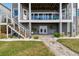 Spacious patio with stairs leading to upper deck and lush landscaping at 5531 2Nd Avenue W Cir, Palmetto, FL 34221