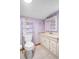 Bathroom with lavender walls and updated vanity at 6 Seminole Dr, Bradenton, FL 34208