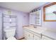 Bathroom with lavender walls and updated vanity at 6 Seminole Dr, Bradenton, FL 34208