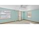 Light blue bedroom with two windows and a door at 6 Seminole Dr, Bradenton, FL 34208