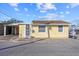 Inviting yellow house with a carport and well-maintained landscaping at 6 Seminole Dr, Bradenton, FL 34208