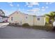 Rear view of the house showing a small yard and utility area at 6 Seminole Dr, Bradenton, FL 34208